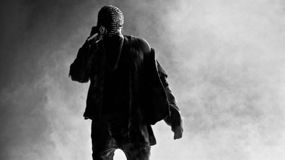 Masked Kanye West black and white image with smoky dry ice background.