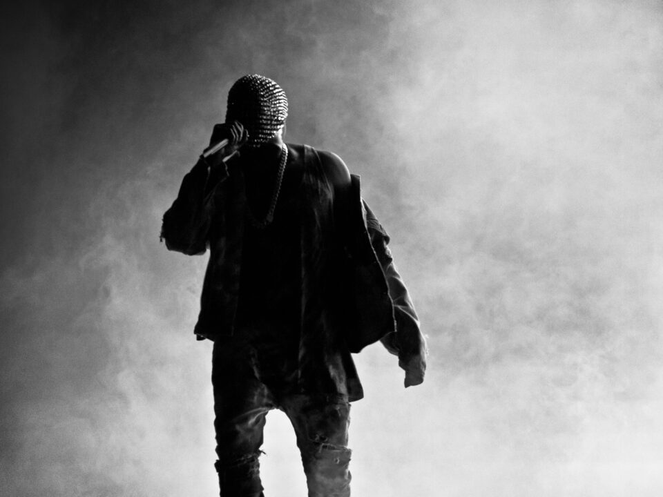 Masked Kanye West black and white image with smoky dry ice background.